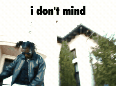 Man Standing In Front Of Building Saying I Don't Mind GIF