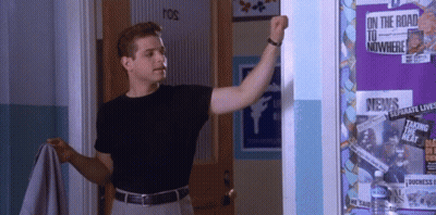 Man Standing In Front Of Bulletin Board Saying On The Road To Nowhere GIF