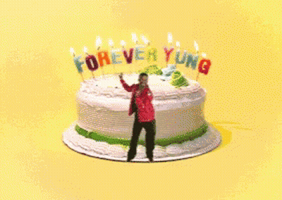 Man Standing In Front Of Cake Saying Forever Young GIF