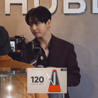Man Standing In Front Of Camera With Sign Saying 120 Beats Per Minute GIF