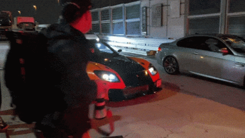 Man Standing In Front Of Car With License Plate A GIF