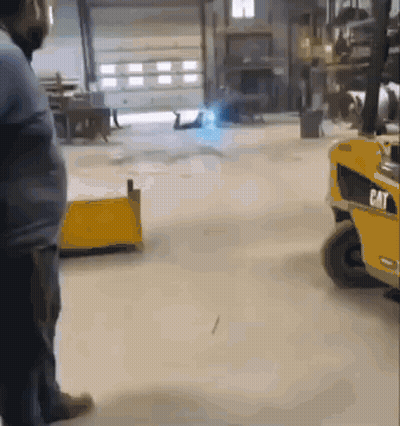 Man Standing In Front Of Cat Forklift GIF