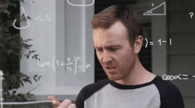 Man Standing In Front Of Chalkboard With Equations GIF