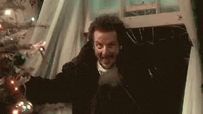 Man Standing In Front Of Christmas Tree GIF