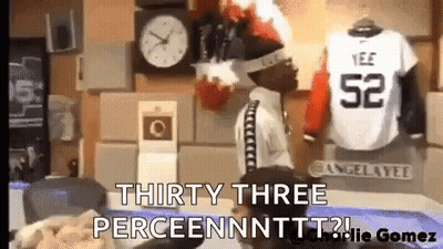 Man Standing In Front Of Clock Next To Jersey Saying 52 GIF