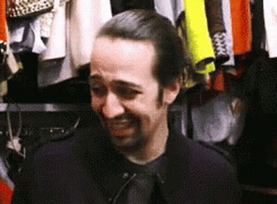 Man Standing In Front Of Closet With Clothes GIF