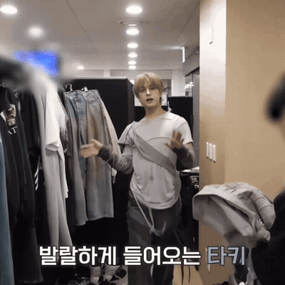Man Standing In Front Of Closet With Foreign Language On Wall GIF