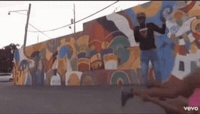 Man Standing In Front Of Colorful Wall GIF