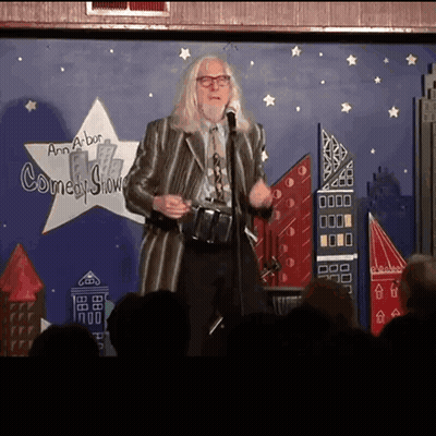 Man Standing In Front Of Comedy Show Sign GIF