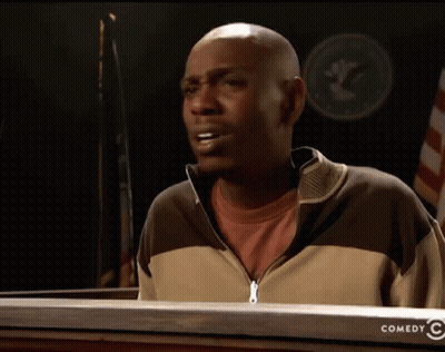 Man Standing In Front Of Comedy Sign GIF