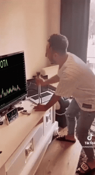 Man Standing in Front of Computer Screen Saying Ota