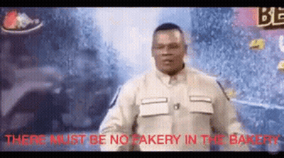 Man Standing In Front Of Crowd Sign No Fakery In The Bakery GIF