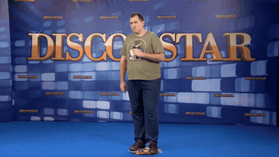 Man Standing In Front Of Disco Star Banner GIF