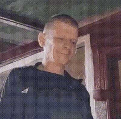 Man Standing In Front Of Door Looking At Camera GIF
