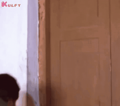 Man Standing in Front of Door Looking Out