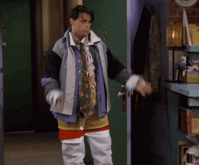 Man Standing In Front Of Door Wearing Jacket And Tie GIF