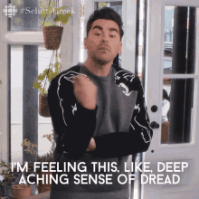Man Standing In Front Of Door With Arms Crossed Says I'm Feeling This GIF