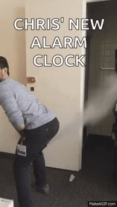 Man Standing In Front Of Door With Chris New Alarm Clock GIF