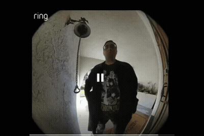Man Standing In Front Of Door With Ring Logo GIF