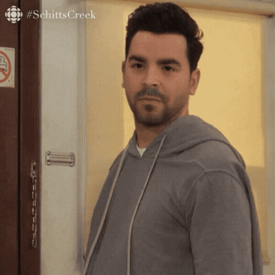 Man Standing In Front Of Door With Schitts Creek GIF