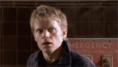 Man Standing In Front Of Emergency Sign GIF