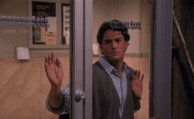 Man Standing In Front Of Emerson Bank Window GIF