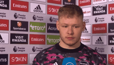 Man Standing In Front Of Emirates Ads GIF