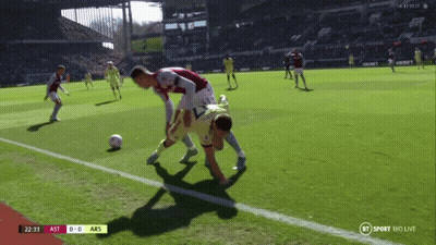 Man Standing In Front Of Emirates TCL And Betway Ads GIF