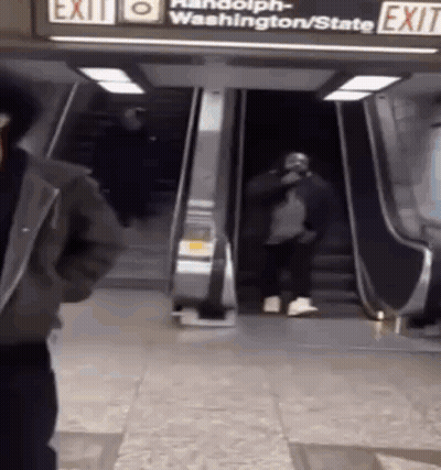 Man Standing In Front Of Exit Escalator GIF