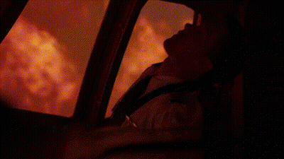 Man Standing In Front Of Fire In Dark Room GIF