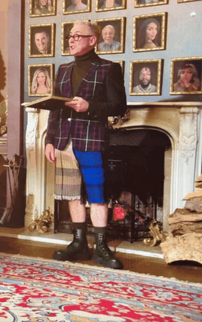 Man Standing In Front Of Fireplace With Pictures GIF
