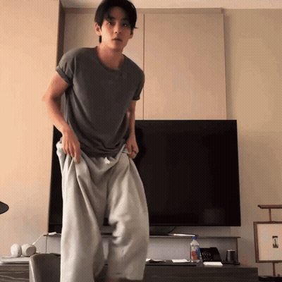 Man Standing In Front Of Flat Screen TV With Aquafina Water GIF