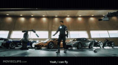 Man Standing In Front Of Garage Full Of Cars GIF