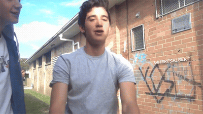 Man Standing In Front Of Graffiti Wall GIF