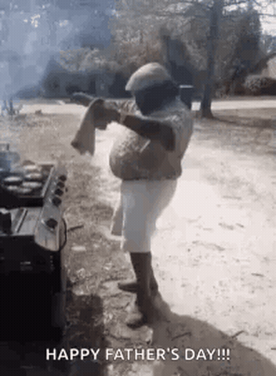 Man Standing In Front Of Grill With Towel On Shoulder GIF