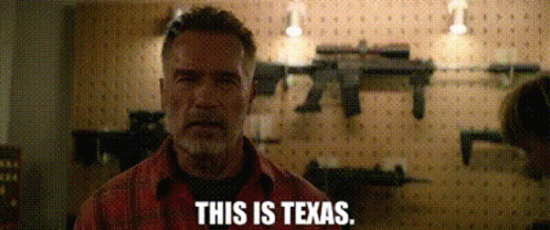 Man Standing In Front Of Guns Wall Texas GIF
