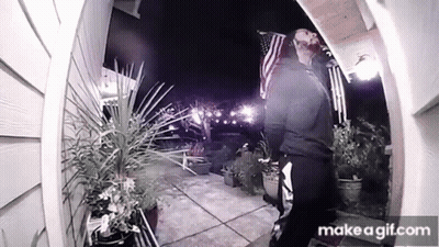 Man Standing In Front Of House With American Flag GIF