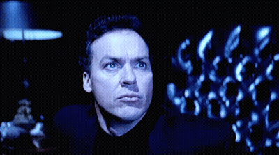 Man Standing In Front Of Large Batman Logo GIF