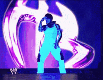 Man Standing In Front Of Large Screen With W Logo GIF