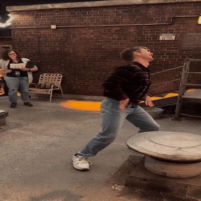 Man Standing In Front Of No Parking Sign On Brick Wall GIF