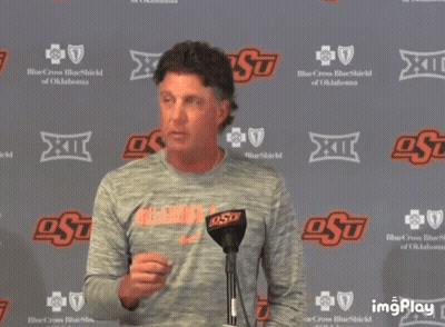 Man Standing In Front Of OSU Wall GIF