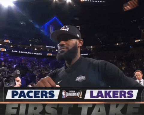 Man Standing In Front Of Pacers And Lakers Sign GIF