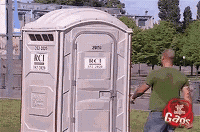 Man Standing In Front Of Portable Toilet Saying RCI GIF