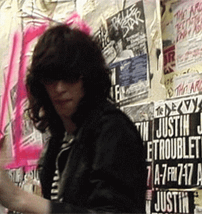 Man Standing In Front Of Posters GIF
