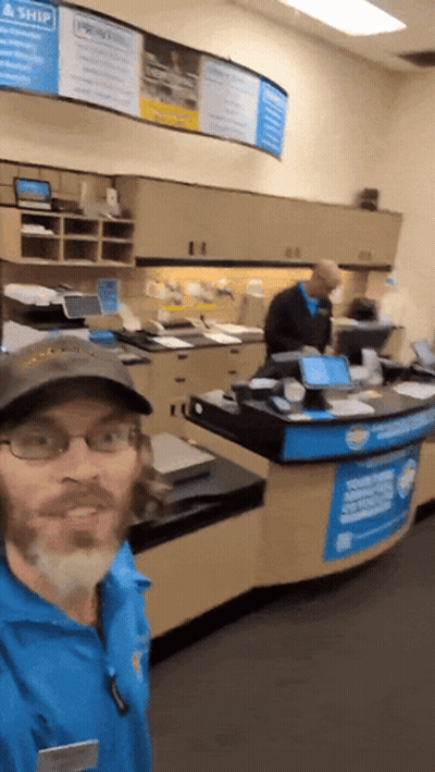 Man Standing In Front Of Priority Mail Sign GIF