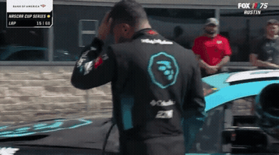 Man Standing In Front Of Race Car With Fox 75 Logo GIF