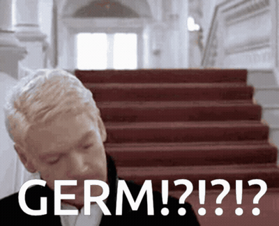 Man Standing In Front Of Red Stairs Saying Germ ? ! ? ! ? GIF