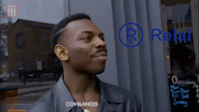 Man Standing In Front Of Relat Sign GIF