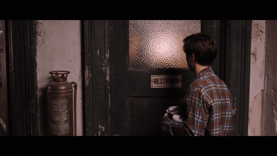 Man Standing In Front Of Restroom Door GIF
