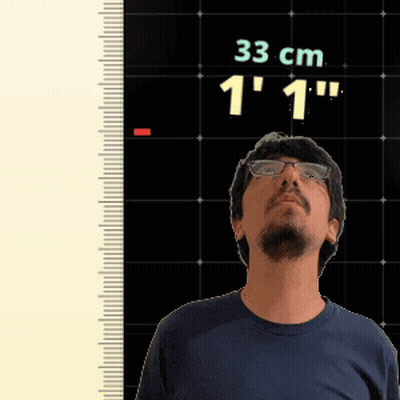 Man Standing In Front Of Ruler Reading 33 Cm GIF